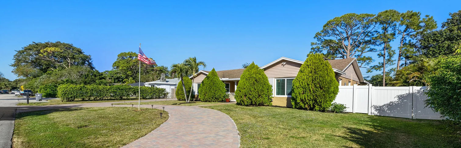 Pathway to the beach with blue umbrellas and ocean view