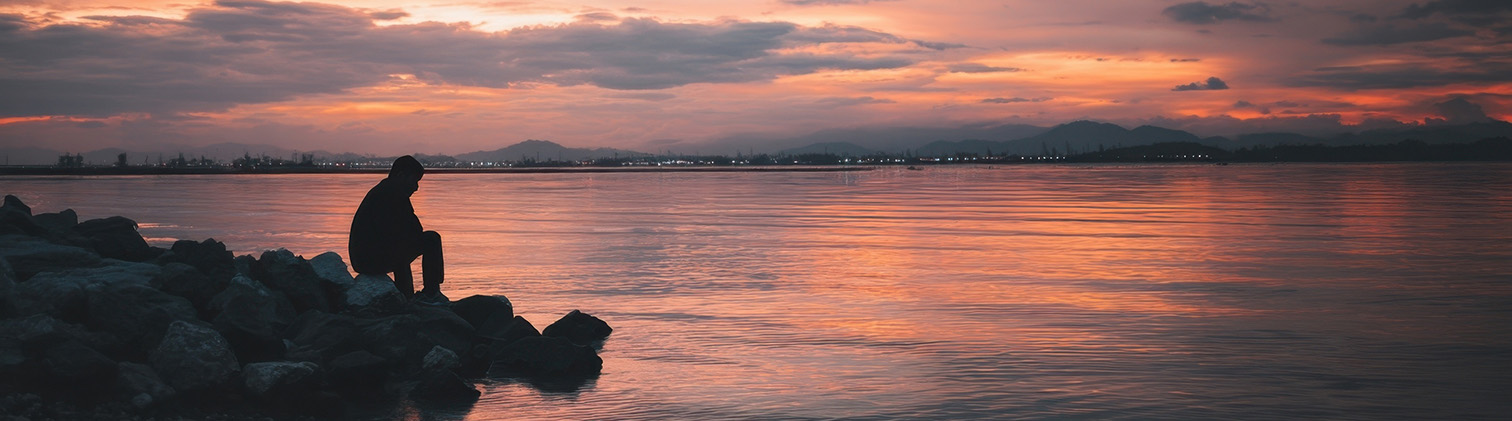 Pathway to the beach with blue umbrellas and ocean view
